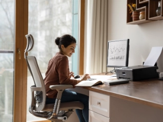 woman behind desk working on computer