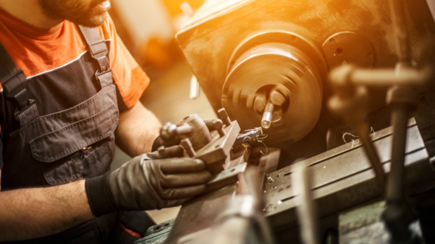 Male engineer drilling machine parts image