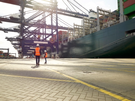 Dock workers beside cargo ship at Port of Felixstowe, England